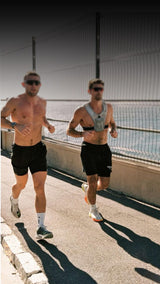 Guys Running on the beach rehydrating with Freak Shake Fuel & Hydrate