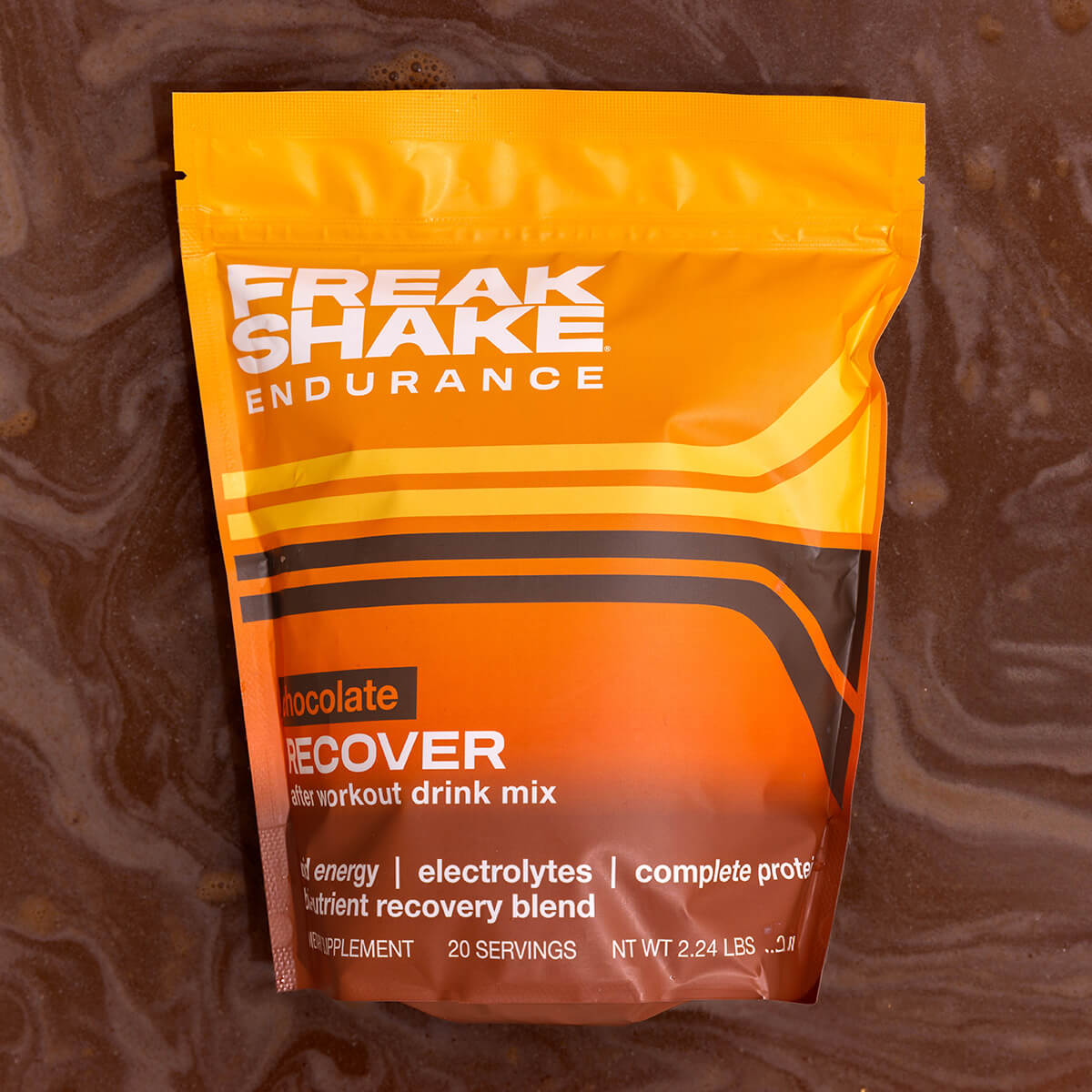 Freak Shake Endurance Chocolate Plant Protein and Carb Recovery Shake on Chocolate Shake Background