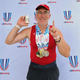 National Championship Rower wearing medals and posing with Grit Fuel Endurance Capsules with Quercetin and Epicatechin
